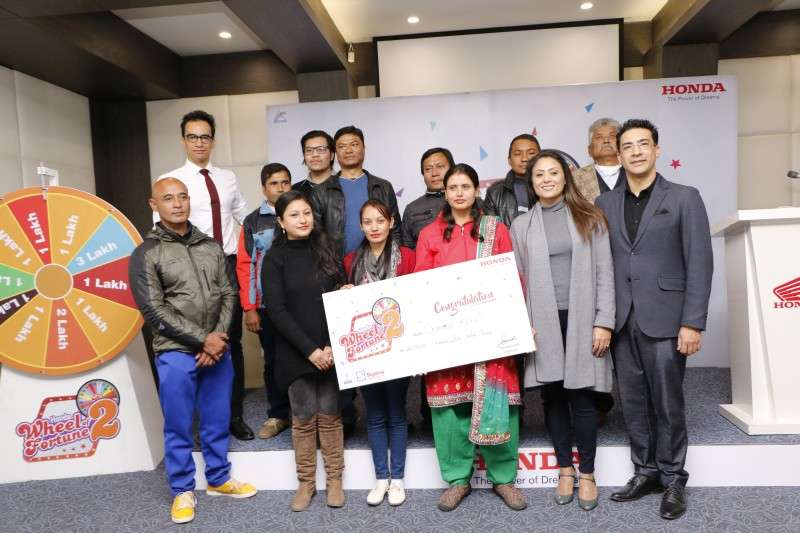 Chandra Koirala of Narayanghat, the winner of Rs 1 million under Honda’s Wheel of Fortune Scheme, receives the amount at Jyoti Bhavan, Kantipath on Monday. Out of the ten lucky winners chosen through lucky draw, another winner was awarded Rs 400,000 while the remaining ones received Rs 100,000 each. Photo: Pradip Luitel/Aarthik Abhiyan