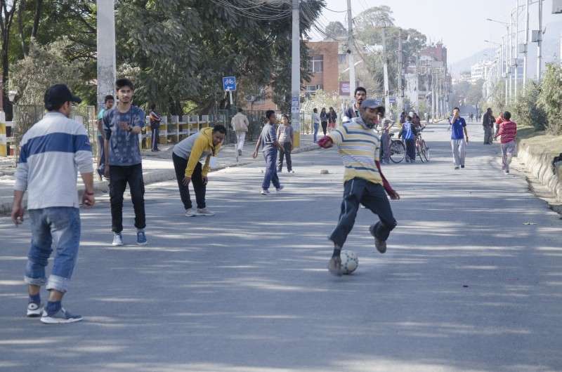 People playing football as vehicles stayed off the road on election day on Thursday. Photo: Aarthik Abhiyan