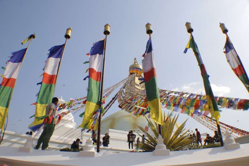 Flags fluttering on the premises of Bouddhanath Stupa on Thursday. This religious site of Buddhists is visited by large number of domestic and foreign tourists every day. Photo: PRadip Luitel/NBA