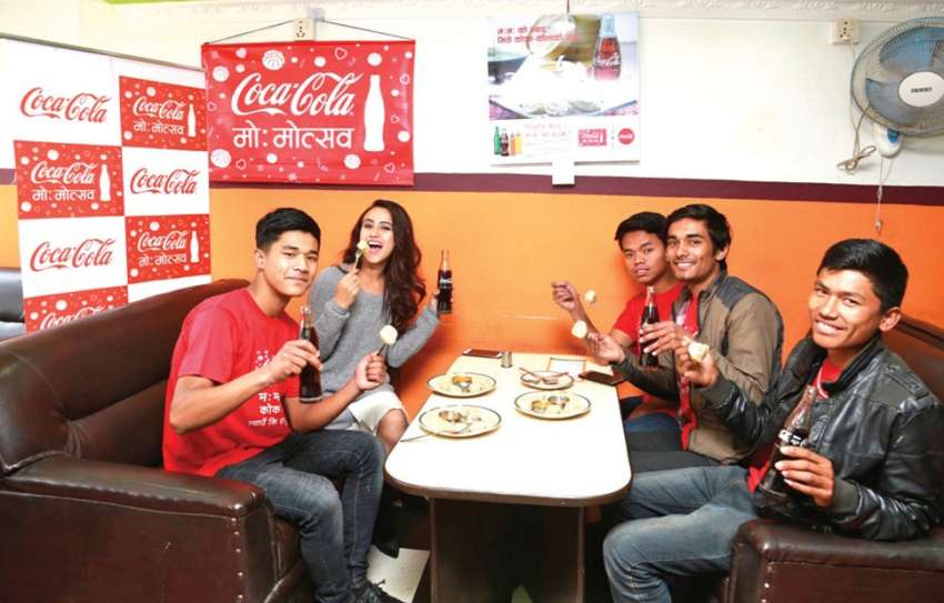 Actress Swastima Khadka celebrating Coca-Cola Mo:Motsav with customers of coke at an outlet in Kathmandu. Photo: NBA