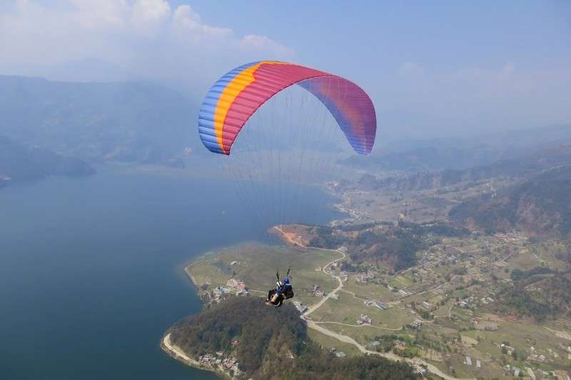 This file photo shows paragliders in a tandem flight in Pokhara. The lake city is all set to host the First Asian Paragliding Tour Championship from February 5 to 9. Photo: Narahari Poudel/NBA