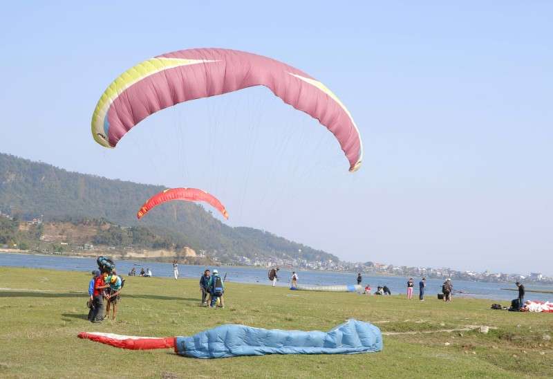 Paragliders landing on the shore of Fewa Lake in Pokhara in this recent photo. A large number of internal and foreign tourists visit Pokhara to watch the mountains, sunrise and also for paragliding. Photo: Pradip Luitel/NBA