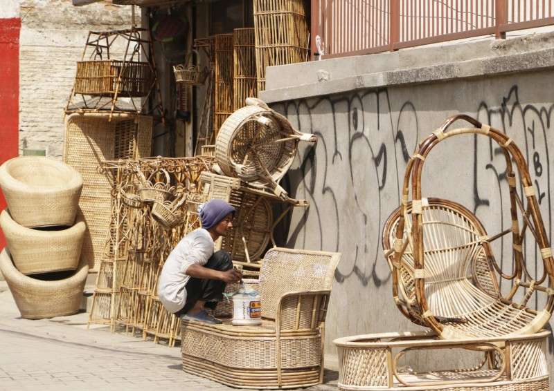 A worker colouring chairs made of bamboo at a shop in Kupondole, Lalitpur. Photo: Pradip Luitel/NBA