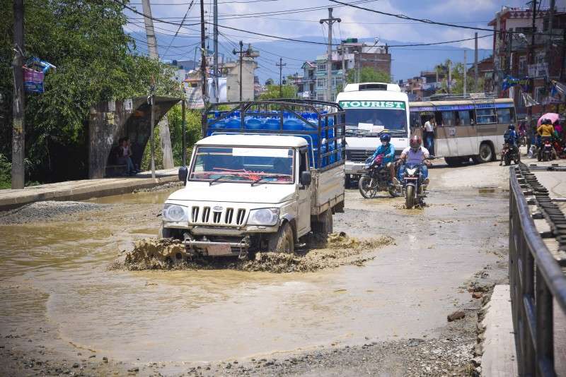 Vehicles plying a waterlogged road in Pepsicola of Kathmandu on Wednesday. Roads in various places in the capital get waterlogged as the construction of the roads have not been completed in time. Photo: Sagar Basnet/NBA