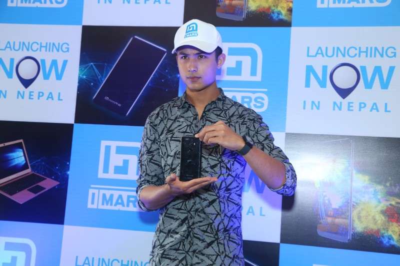 Actor Anmol KC poses for a photo with IMARS brand of smartphones after being appointed as the brand ambassador of the company.