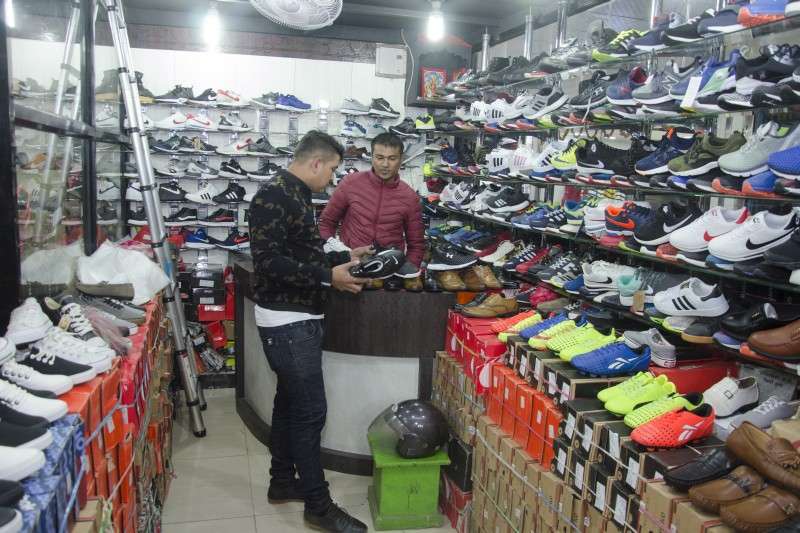 A local looks at shoes at a wholesale shop at New Road-based Ranjana Traders. Photo: Sagar Basnet/Aarthik Abhiyan