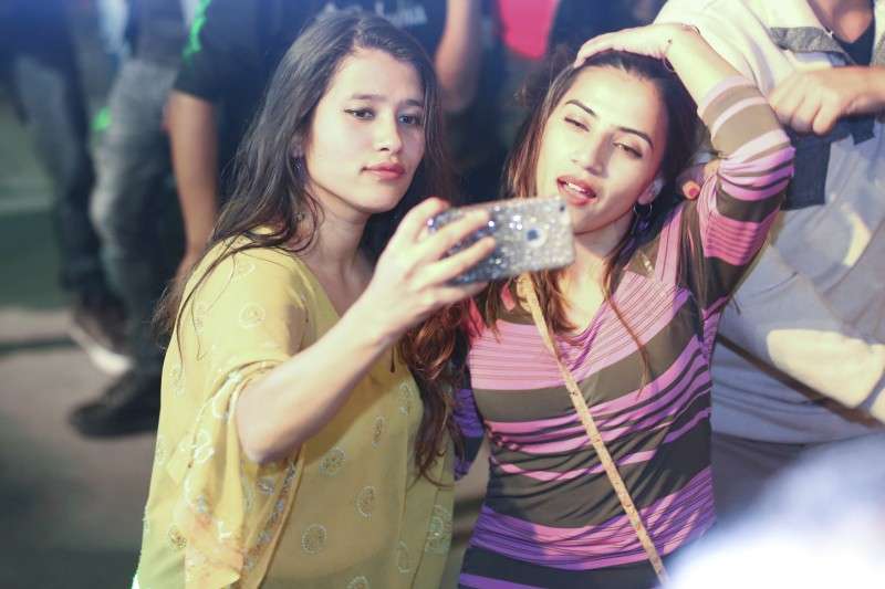 Young women taking selfie during Christmas Day in the capital on Monday. Photo: Sagar Basnet/Aarthik Abhiyan
