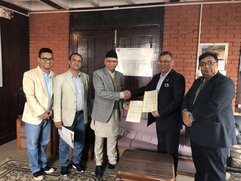 Prof Dr Shrikrishna Giri of the Ministry of Health and Om Rajbhandari, president of Nepal Ambulance Service, shake hands after signing an agreement to establish an emergency medical system in Nepal. As per the agreement,  the government will bring all ambulances under one single operating number 102. Photo Courtesy: Prisma PR