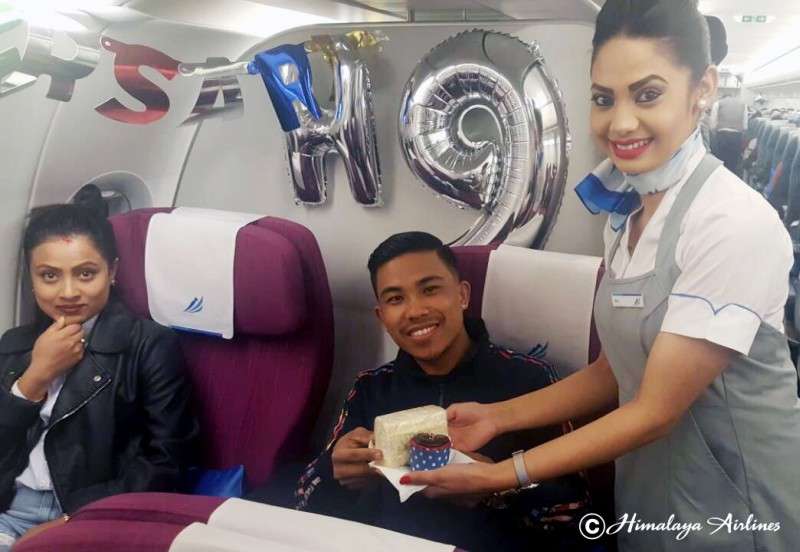 An air hostess of Himalaya Airlines serves delicacies to passengers on the occasion of the airline company’s third anniversary on March 9. Photo Courtesy: Himalaya Airlines