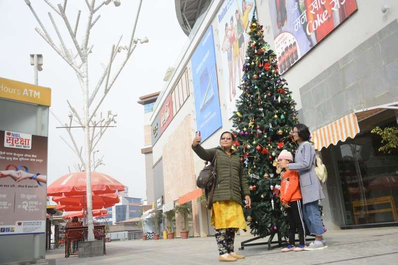 Visitors taking selfie in front of a Christmas tree at Labim Mall in Lalitpur in this recent photo. Photo: Ravi Maharjan/NBA