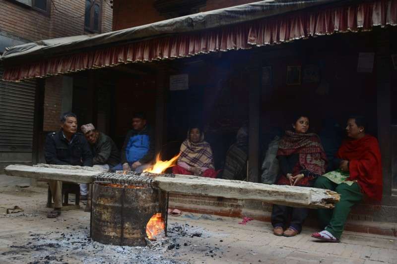 Locals of Kumaripati, Lalitpur enjoying the warmth of fire wood on a cold day. The Kathmandu Valley and other parts of the country has been witnessing excessive cold due to the effect a cyclone in the Bay of Bengal. Photo: Ravi Maharjan/NBA